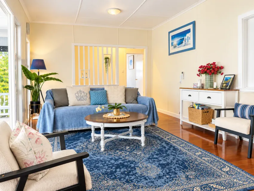 Living room with blue rug, sofas and timber floors at Margate Getaway