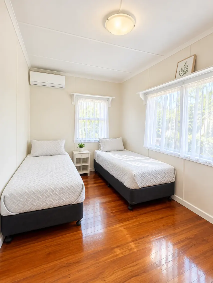 Twin bedroom with two single beds and timber floors at Margate Getaway